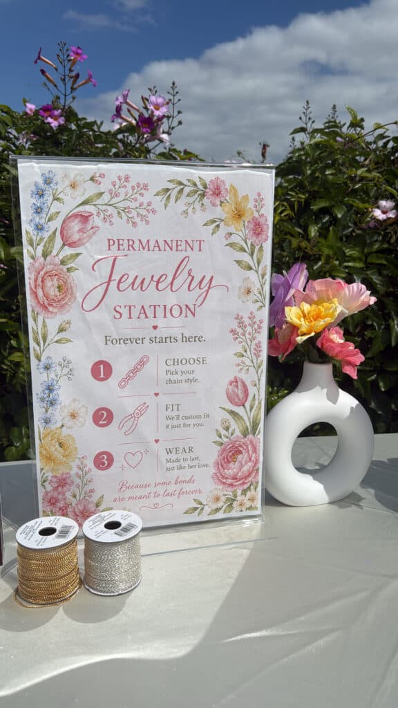 A permanent jewelry station display with sample chains.